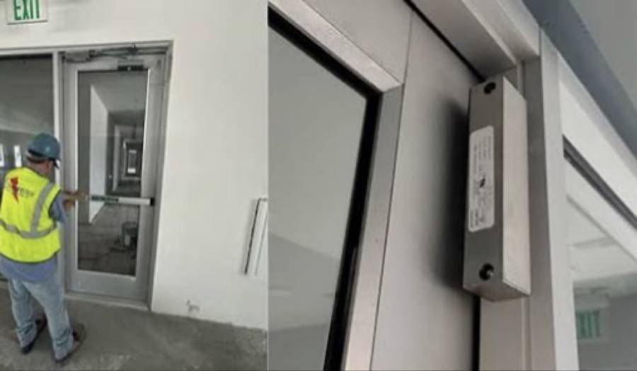 Installer fitting a mag-lock on a commercial door